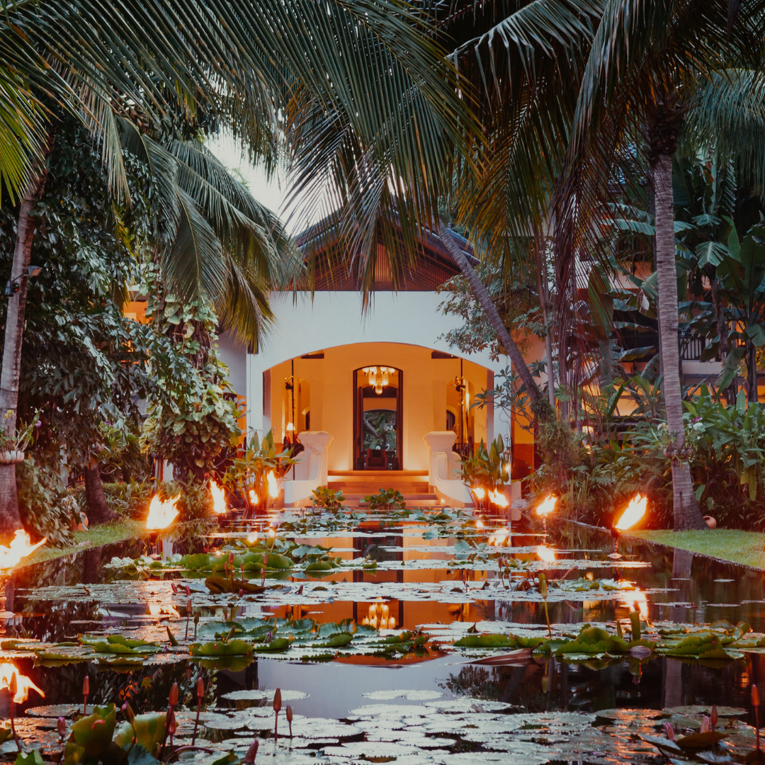 a pond with lily pads and fire in the middle of a house