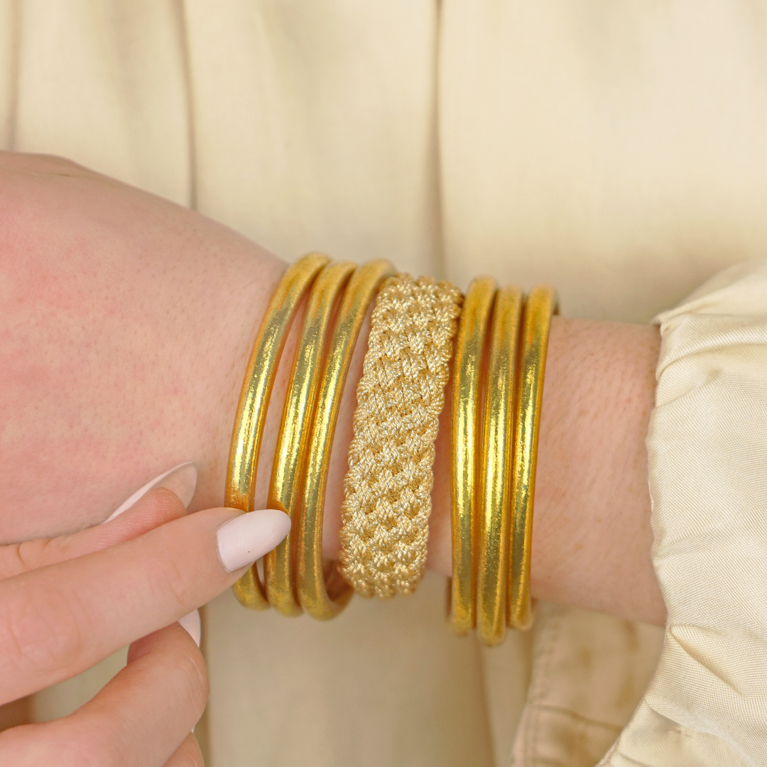 a person wearing gold bracelets