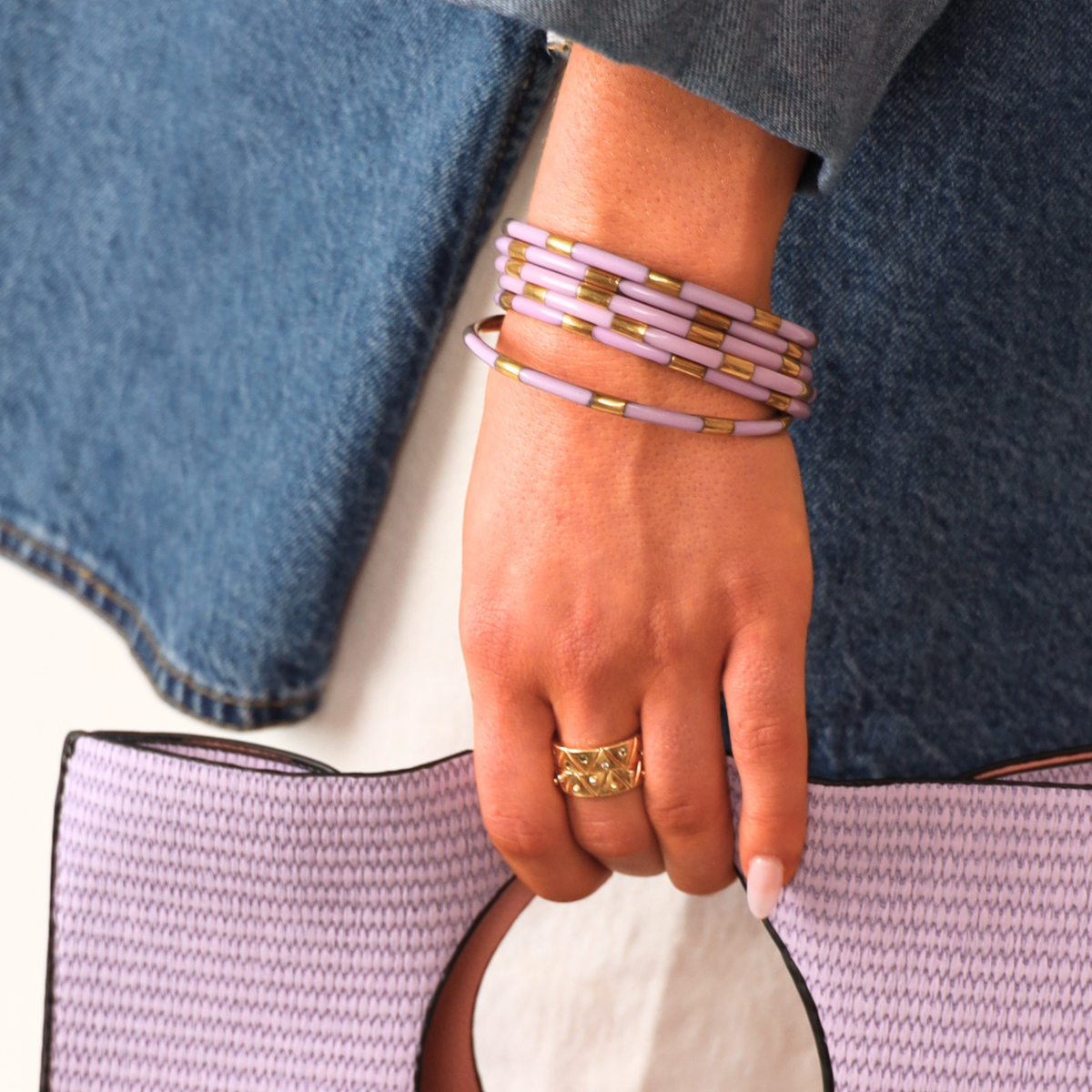 a hand holding a purple bag