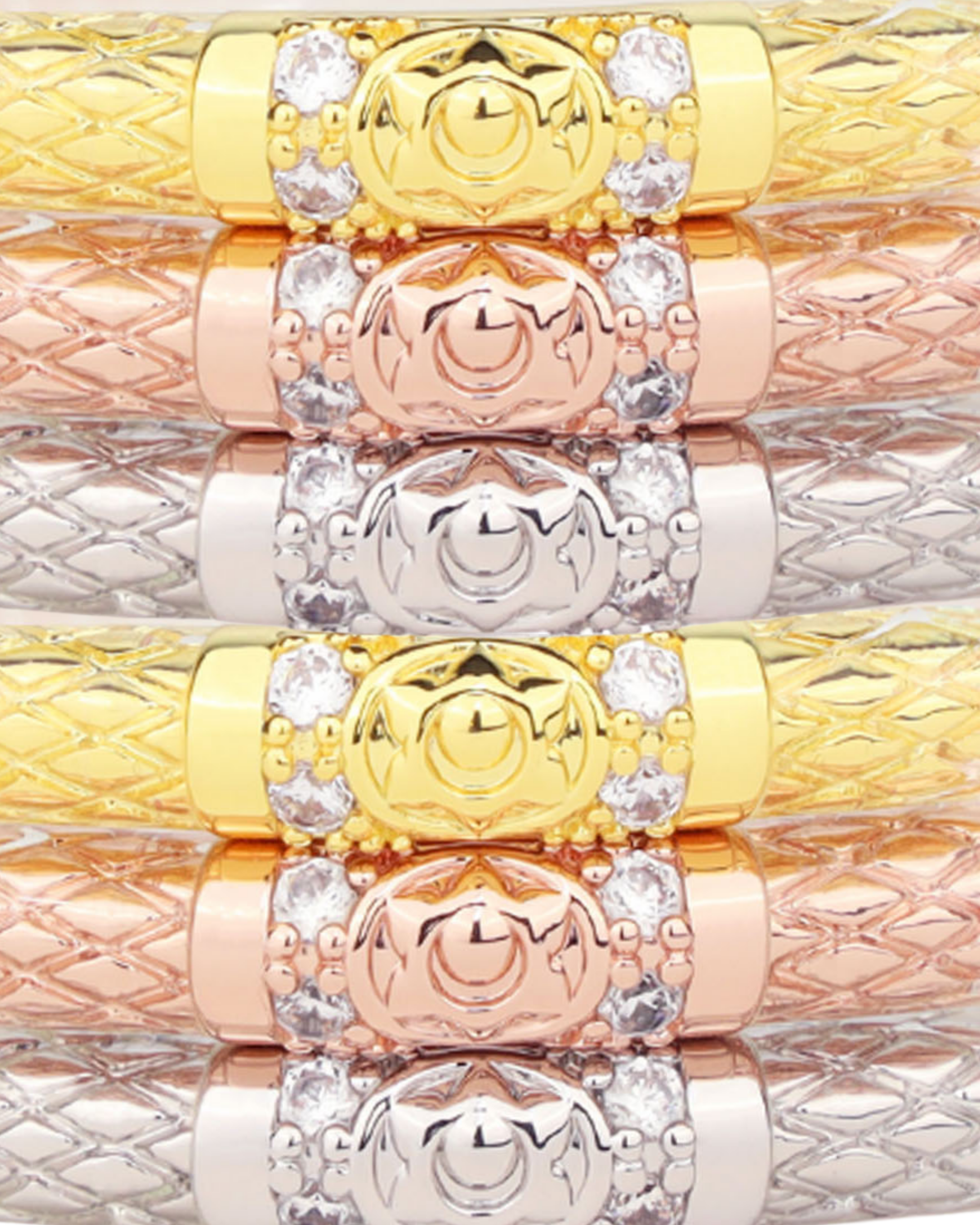 a stack of gold and silver bracelets