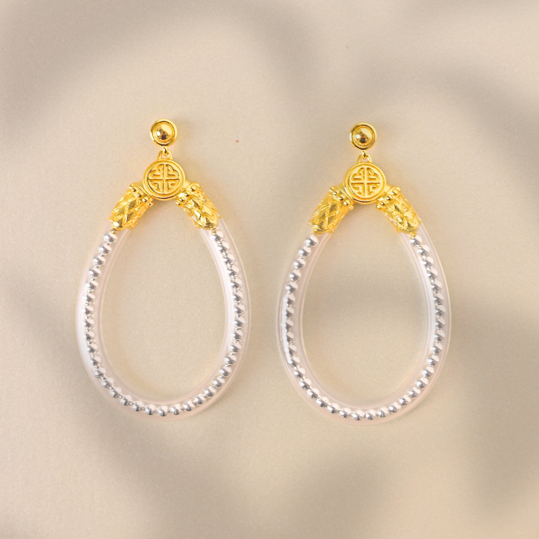 a pair of earrings on a white surface