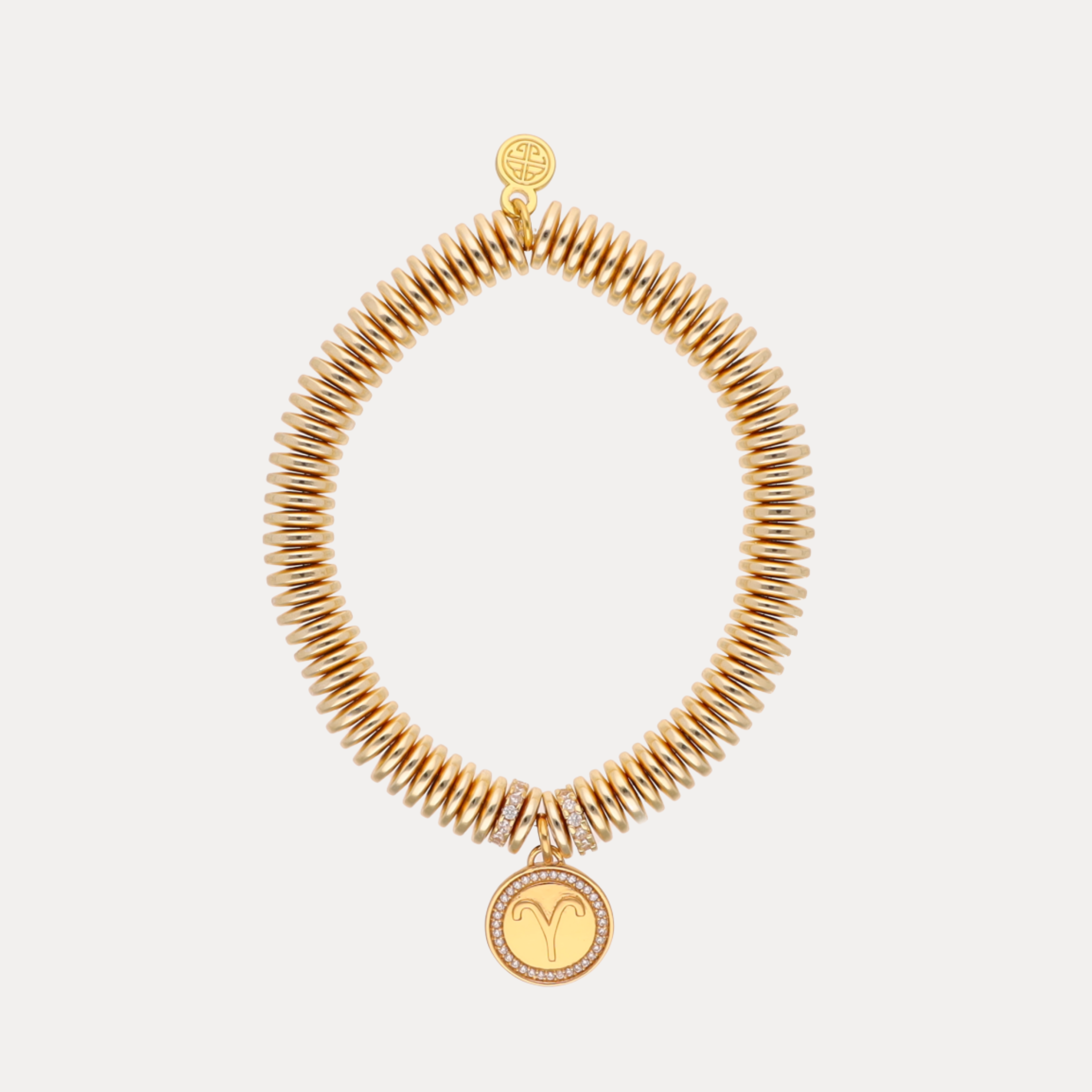 a gold bracelet with a round pendant