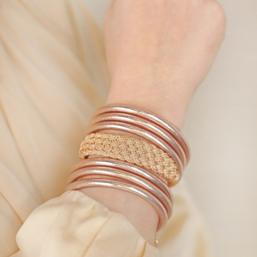 a person wearing gold bracelets