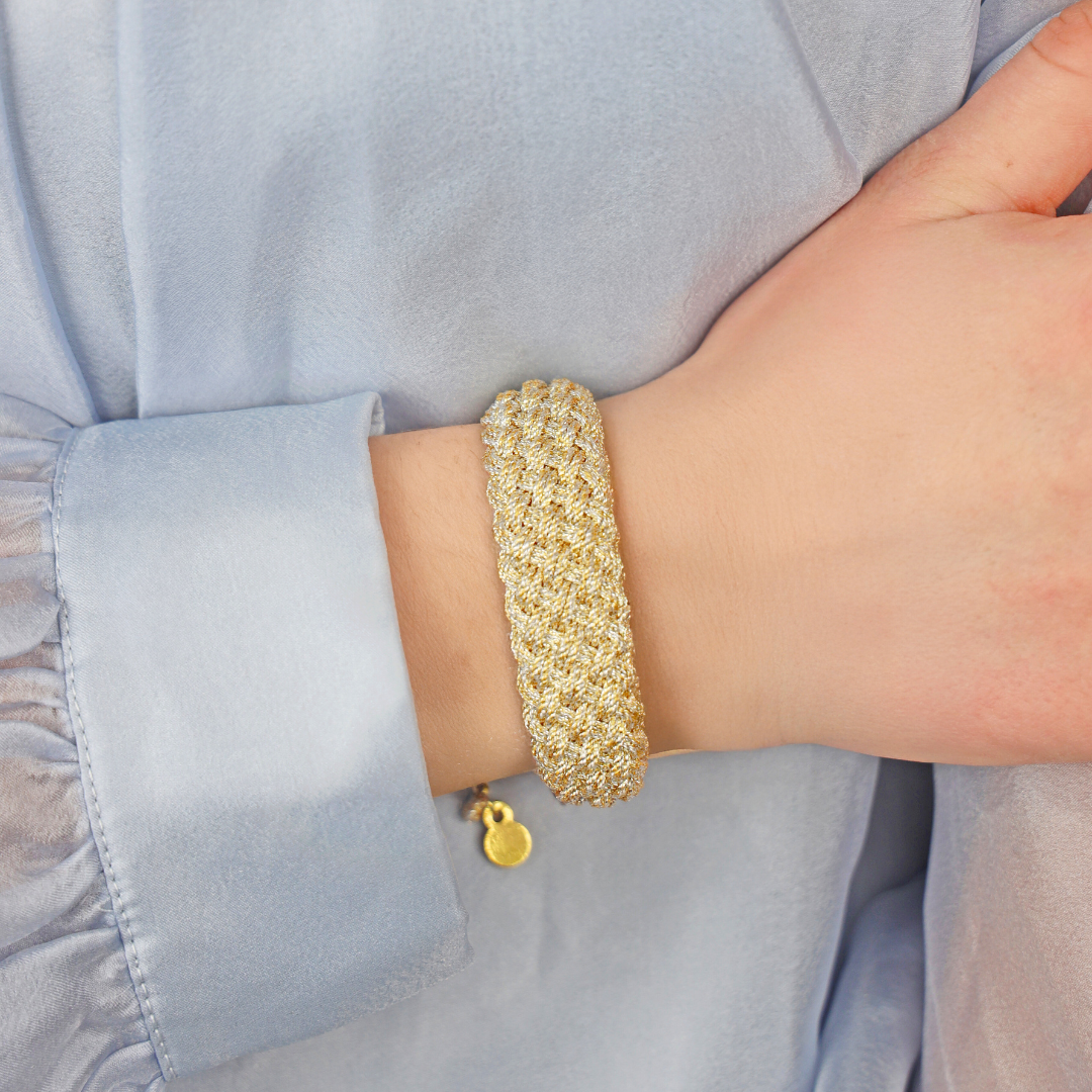 a person wearing a gold bracelet