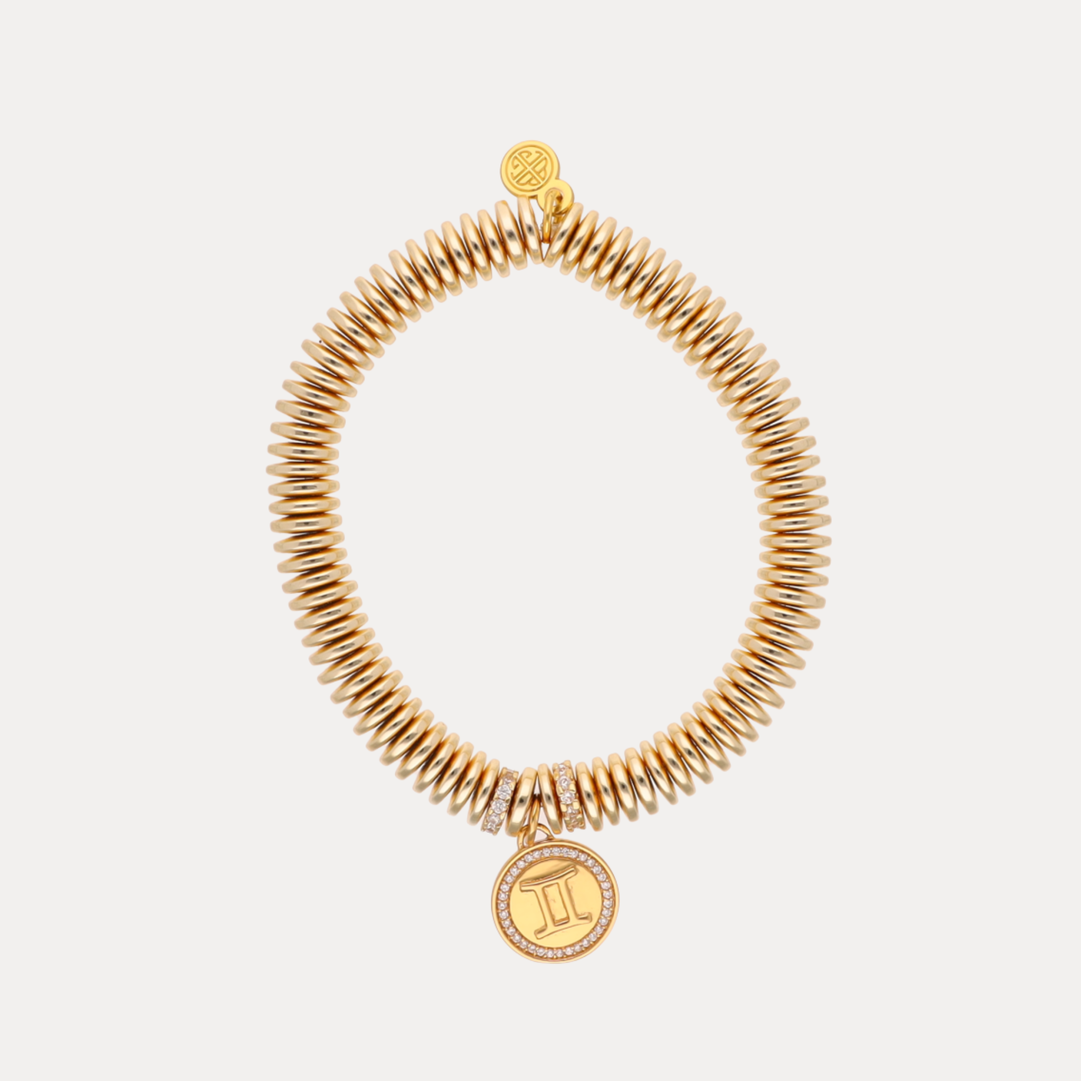 a gold bracelet with a pendant