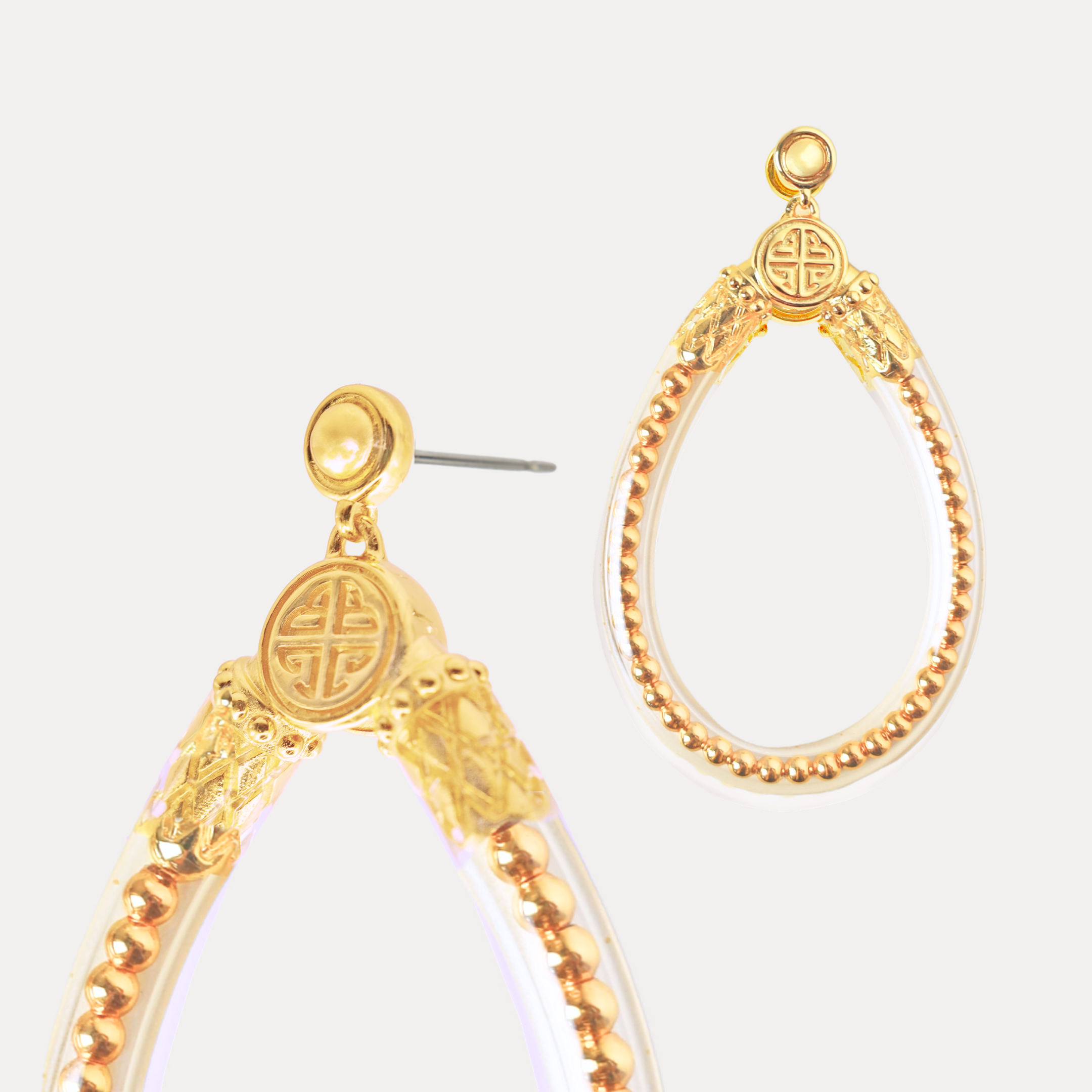a pair of gold earrings