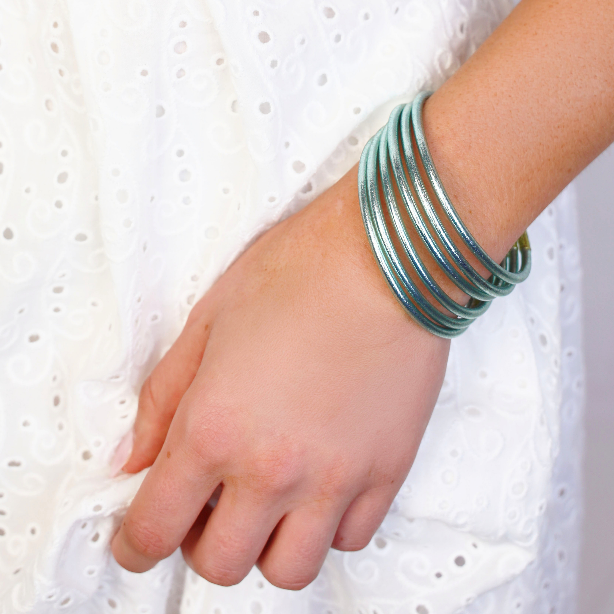 a hand wearing bracelets