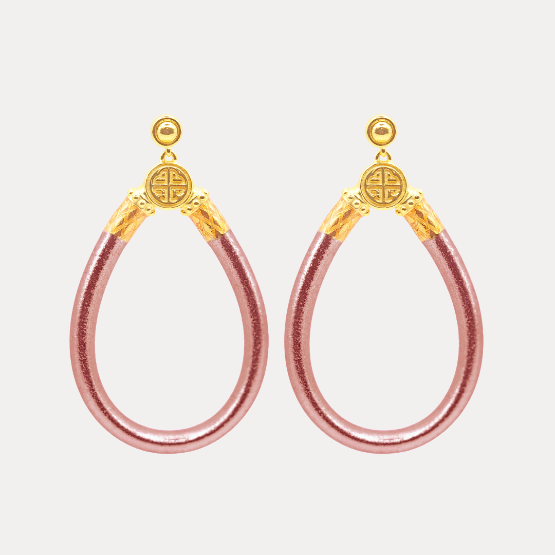 a pair of pink and gold earrings