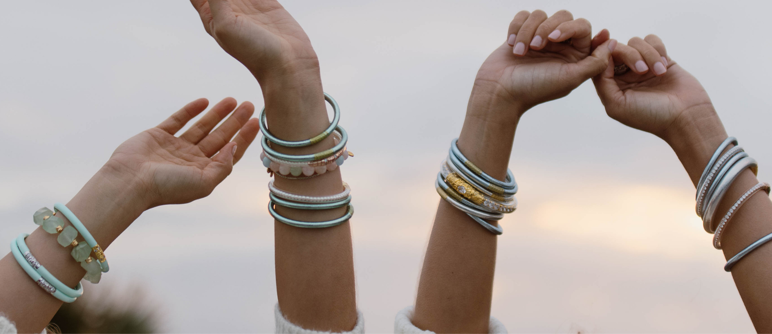 a pair of hands with bracelets