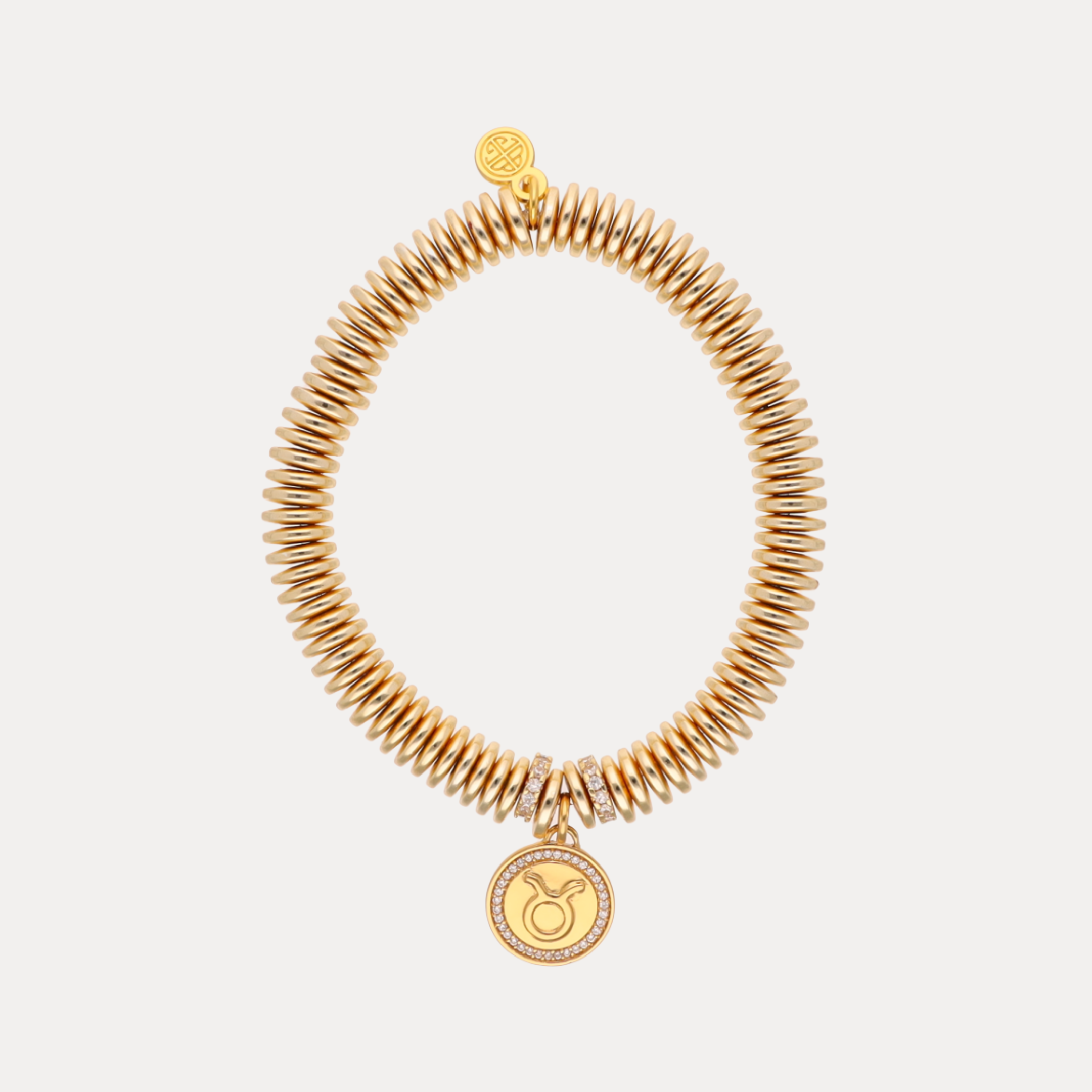 a gold bracelet with a pendant