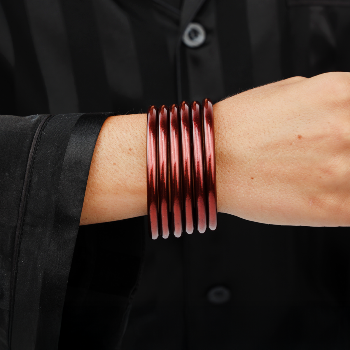 a person wearing a red bracelet