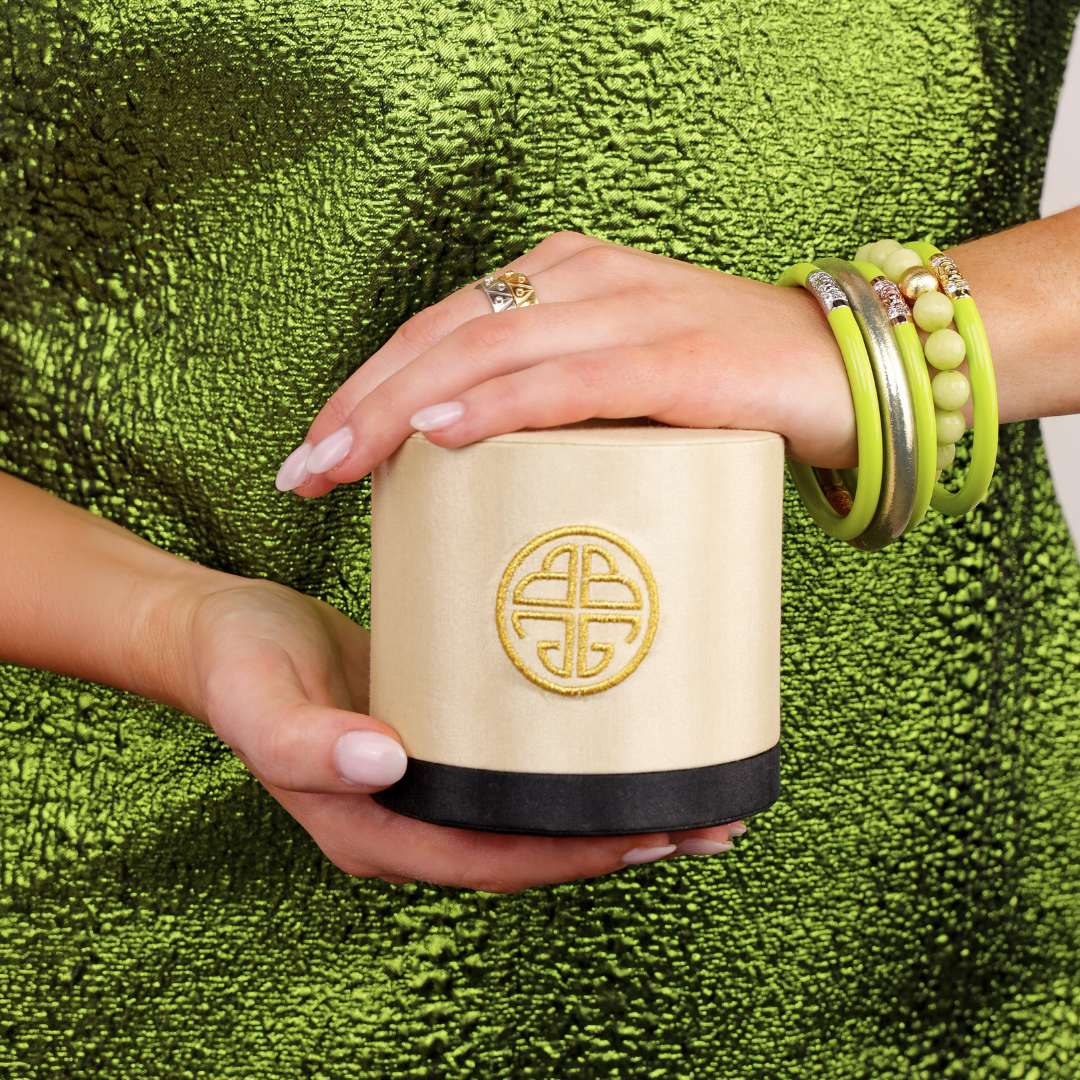 a woman holding a round box