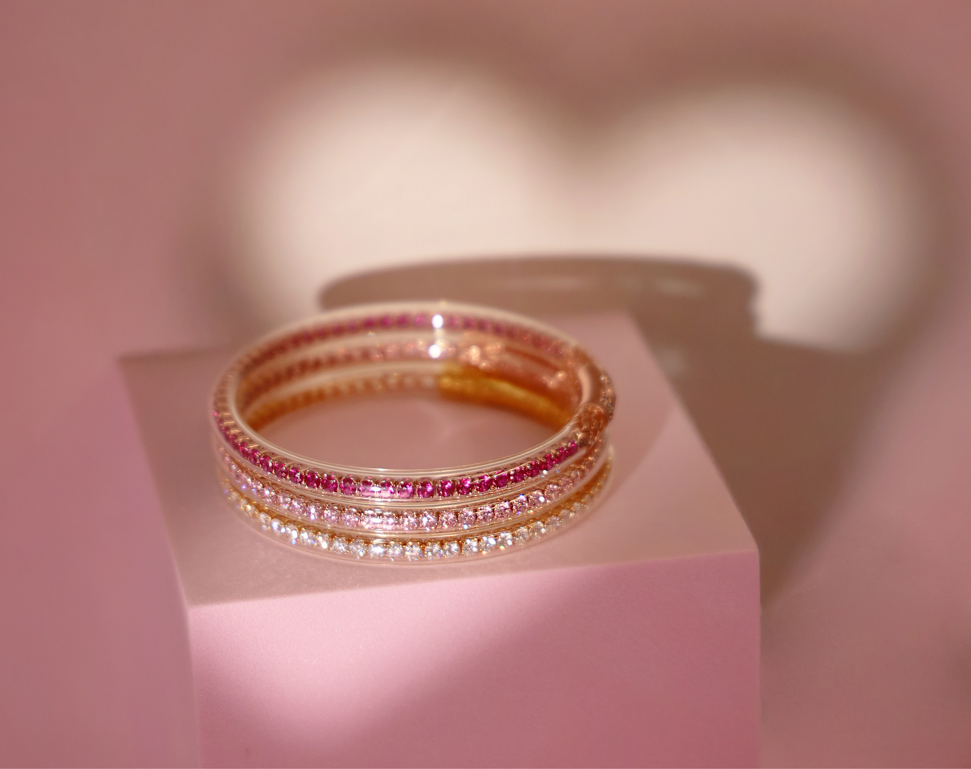 Valentine's Pink Three Queen All Weather Bangles Stack with a heart shadow