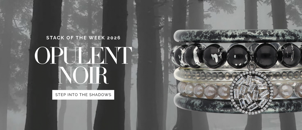Stacked black and silver bangle bracelets with ornate details against a misty forest backdrop and the words Opulent Noir and Step Into the Shadows